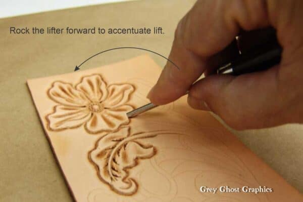 With the lifter inserted into the flower petal, it is rotated up and forward to accentuate the lift.